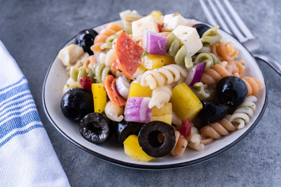 This easy pasta salad with pepperoni is quick and delicious! It’s great for dinner with the family or a party! #pastasalad #partyrecipe #bbq #atablefullofjoy #italianpastasalad #antipasta #sidedish #summer