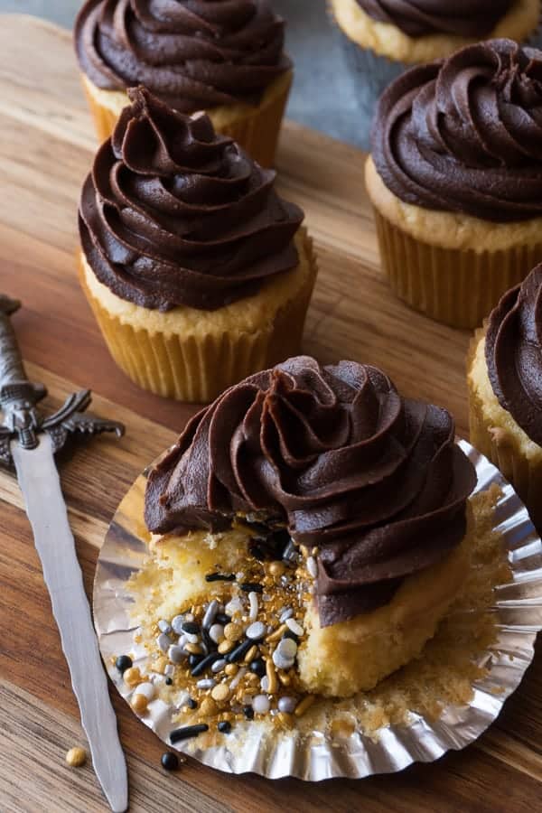 Yellow Cupcake with Chocolate Frosting Filled with gold, silver, black sprinkles.