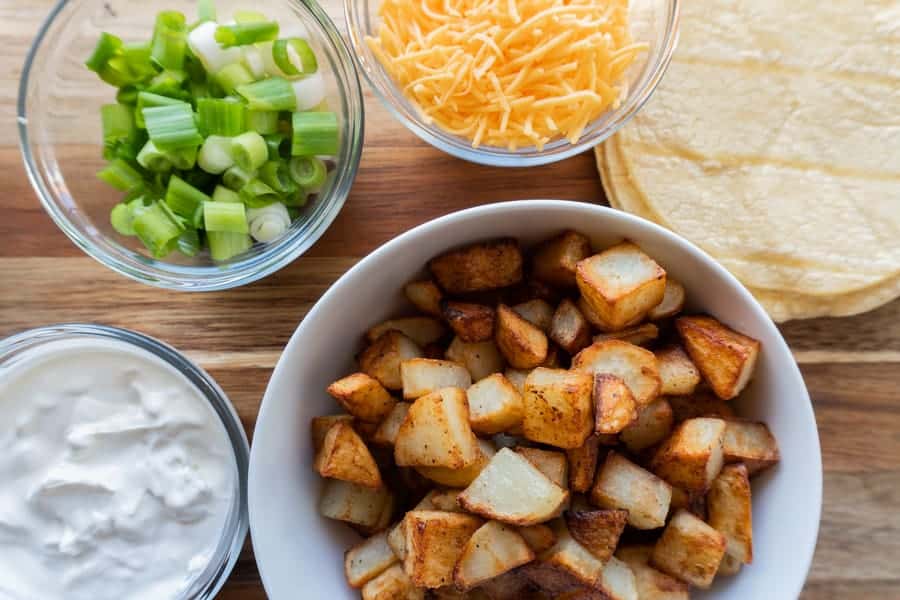 Potato Tacos, A simple and delicious potato taco recipe. Easy to make with only 2 required ingredients, a few spices, and then your favorite toppings! #atablefullofjoy #vegan #vegetarian #potatotacos #tacotuesday #cincodemayo #potato