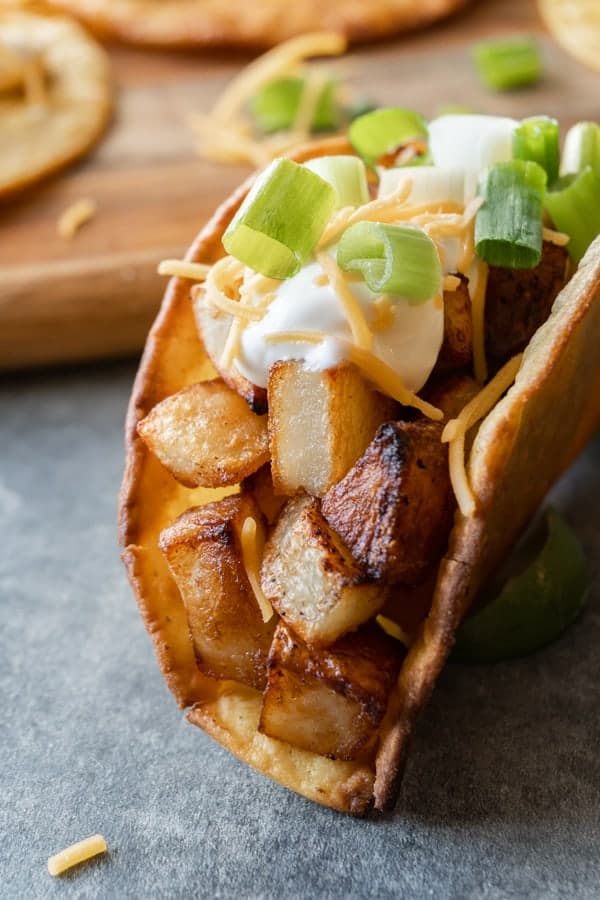 Potato Tacos, A simple and delicious potato taco recipe. Easy to make with only 2 required ingredients, a few spices, and then your favorite toppings! #atablefullofjoy #vegan #vegetarian #potatotacos #tacotuesday #cincodemayo #potato