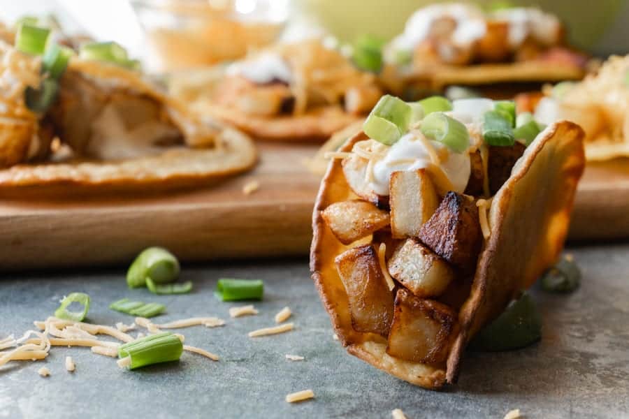 Potato Tacos, A simple and delicious potato taco recipe. Easy to make with only 2 required ingredients, a few spices, and then your favorite toppings! #atablefullofjoy #vegan #vegetarian #potatotacos #tacotuesday #cincodemayo #potato