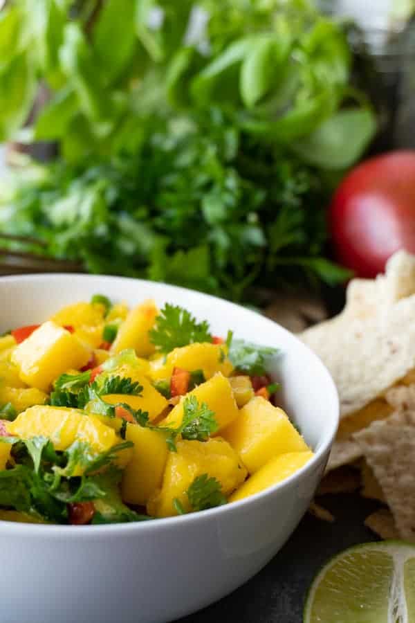 Easy Mango Salsa Recipe, A super easy, and super quick mango salsa recipe that will have your taste buds dancing! Top your favorite tacos or use chips! Either way this mango salsa recipe is what you need in your life! #atablefullofjoy #tacotable #tacotuesday #mangosalsa #mangopineapplesalsa #pineapplesalsa #salsa #cincodemayo