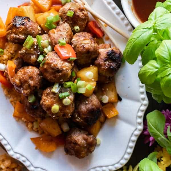 Sweet and Sour Meat Balls, a delicious meatball recipe that will have you making these over and over again! Dairy, Soy, and Gluten free you won’t want to miss this tasty healthy dinner! #meatballs #paleo #paleomeatballs #sweetandsour #glutenfree #dairyfree #soyfree #dinner #atablefullofjoy #asian #pork #baked