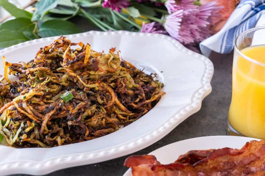 Zucchini Hash Browns are the perfect way to get some veggies in while still enjoying a favorite breakfast treat! These zucchini hash browns are so tasty you won’t even know there is zucchini in them! #healthy # veggie #hash brown #zucchini #forkids #glutenfree #atablefullofjoy #crispy #tasty #vegan #lowcarb