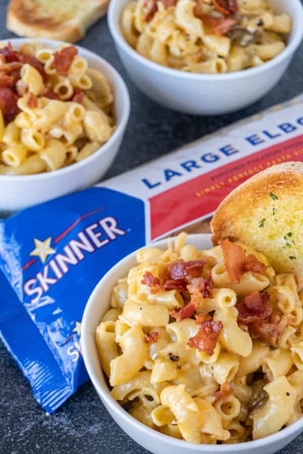 Mac and Cheese in bowl with pasta bag in background